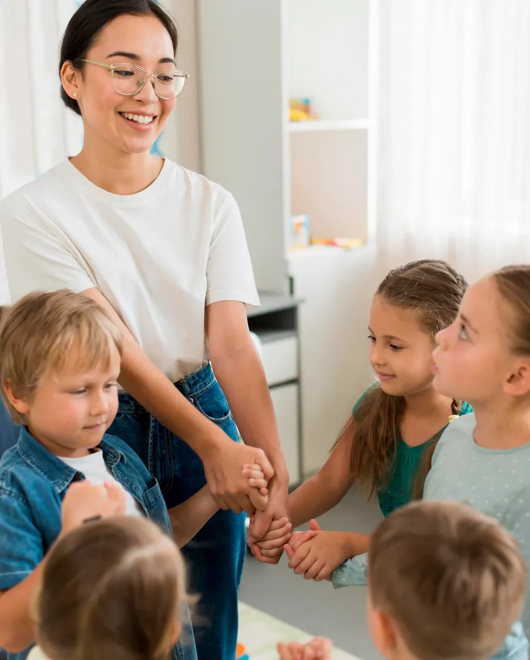 Woman playing with her students indoors